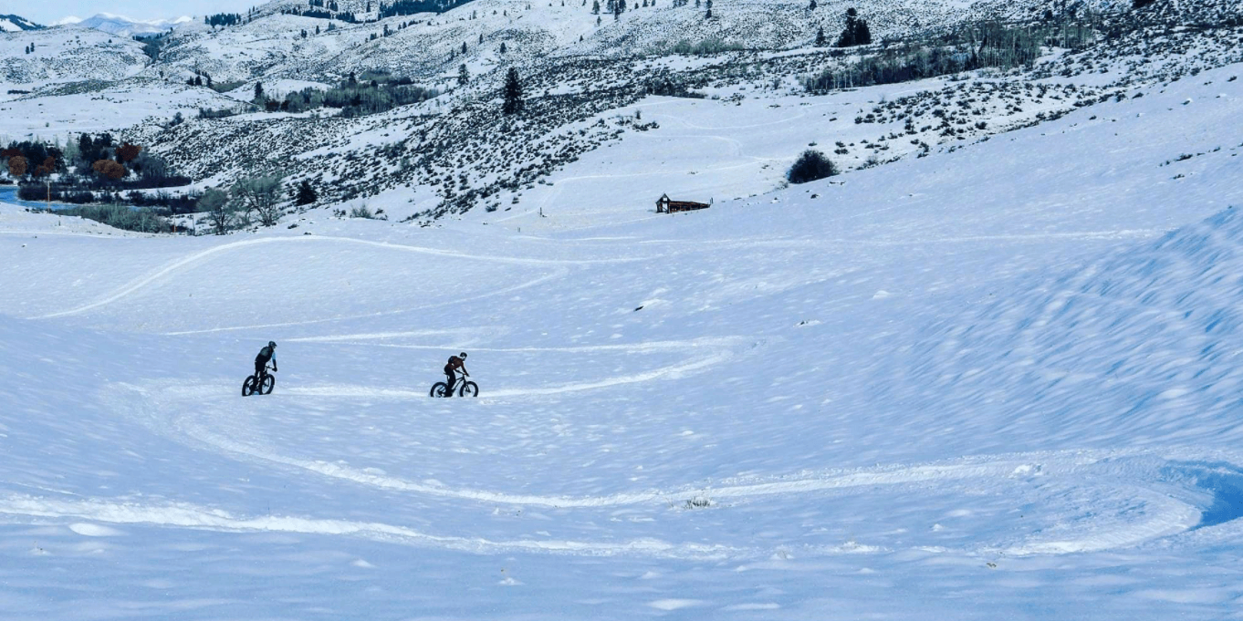 people-riding-fat-bike-on-snow-trail People riding Fat bikes on snow trail